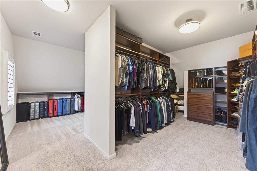 16750 Quayside Drive Milton, GA 30004 - Photo 23 of 53 a view of walk in closet with clothes and shoes
