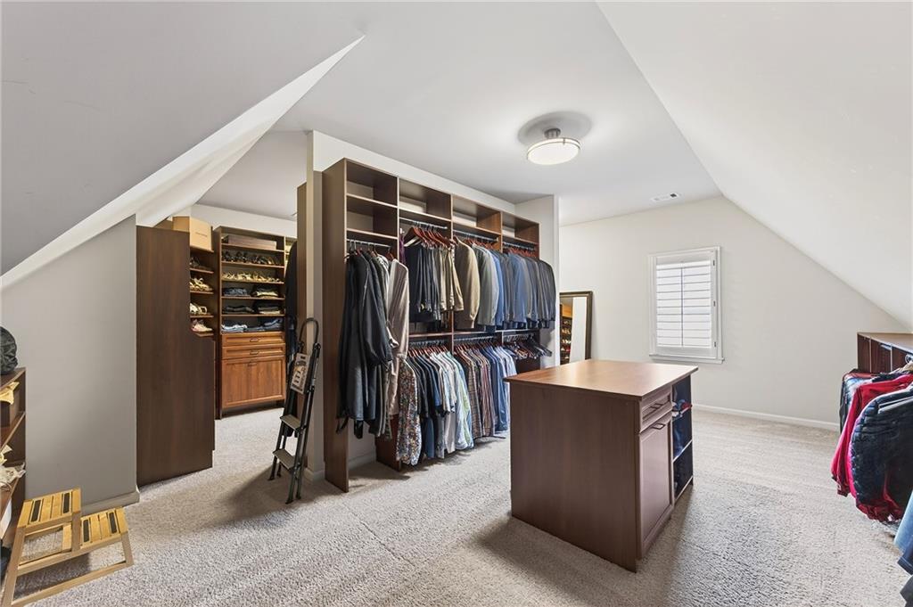 16750 Quayside Drive Milton, GA 30004 - Photo 24 of 53 a view of walk in closet with clothes and shoes