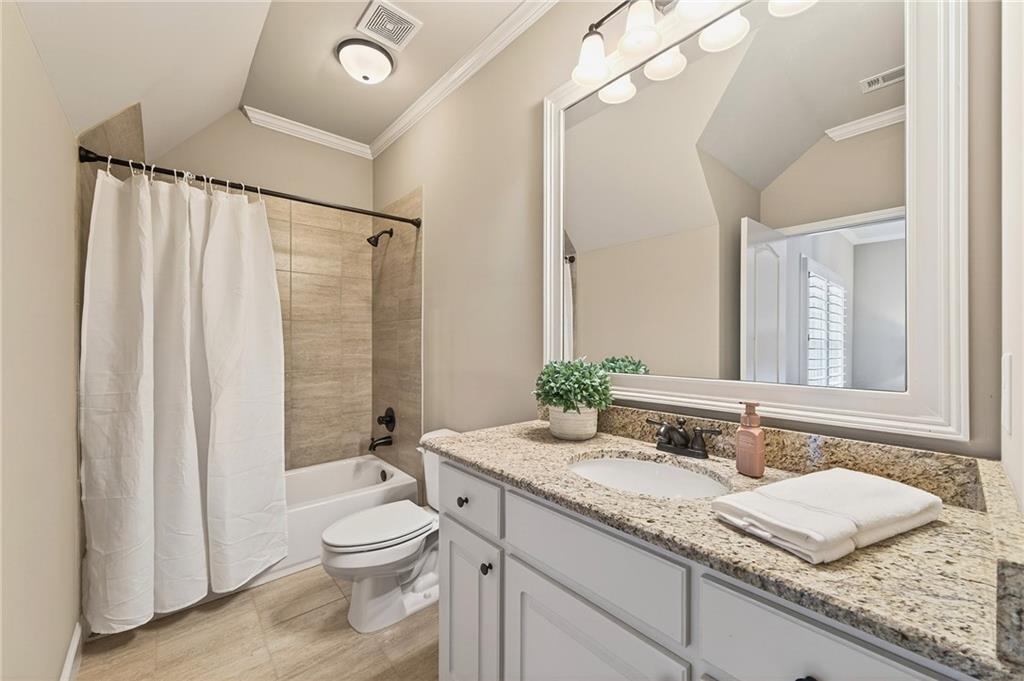 16750 Quayside Drive Milton, GA 30004 - Photo 26 of 53 a bathroom with a granite countertop sink toilet and shower