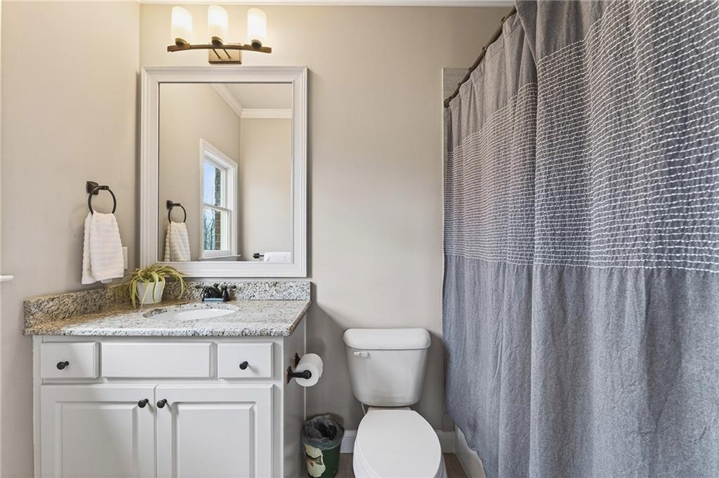 16750 Quayside Drive Milton, GA 30004 - Photo 28 of 53 a bathroom with a granite countertop sink toilet and mirror