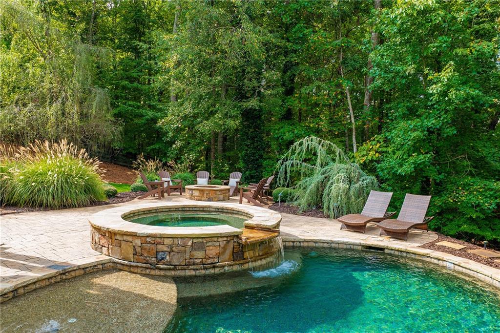 16750 Quayside Drive Milton, GA 30004 - Photo 3 of 53 a view of a swimming pool with a patio and plants
