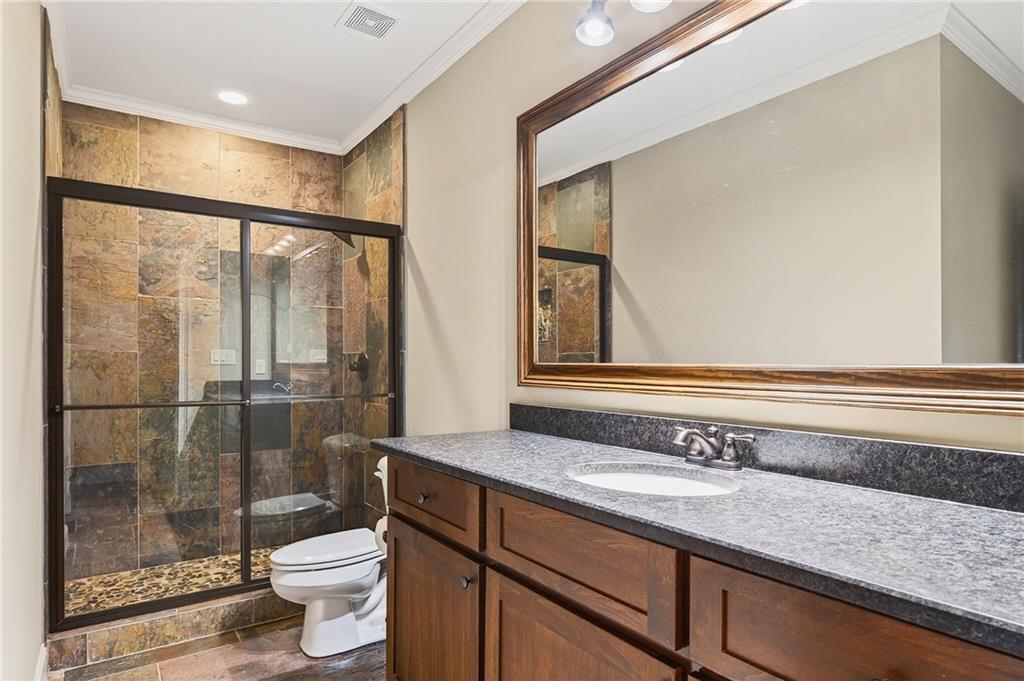 16750 Quayside Drive Milton, GA 30004 - Photo 37 of 53 a bathroom with a sink a toilet a mirror and shower