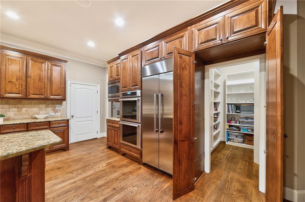 16750 Quayside Drive Milton, GA 30004 - Photo 10 of 53 a kitchen with stainless steel appliances granite countertop a refrigerator and a sink