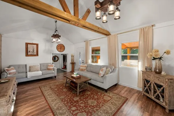 a living room with furniture and wooden floor