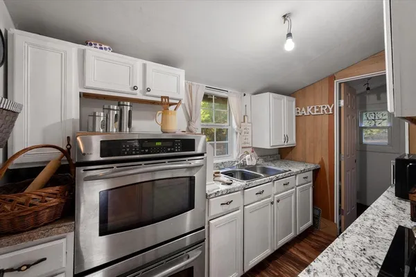 a kitchen with stainless steel appliances granite countertop a stove and a refrigerator