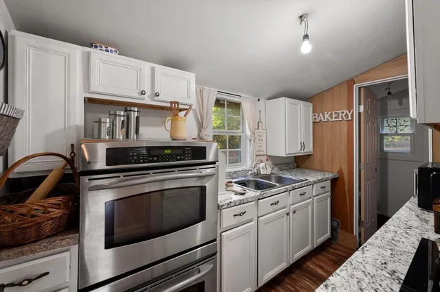 a kitchen with stainless steel appliances granite countertop a stove and a refrigerator