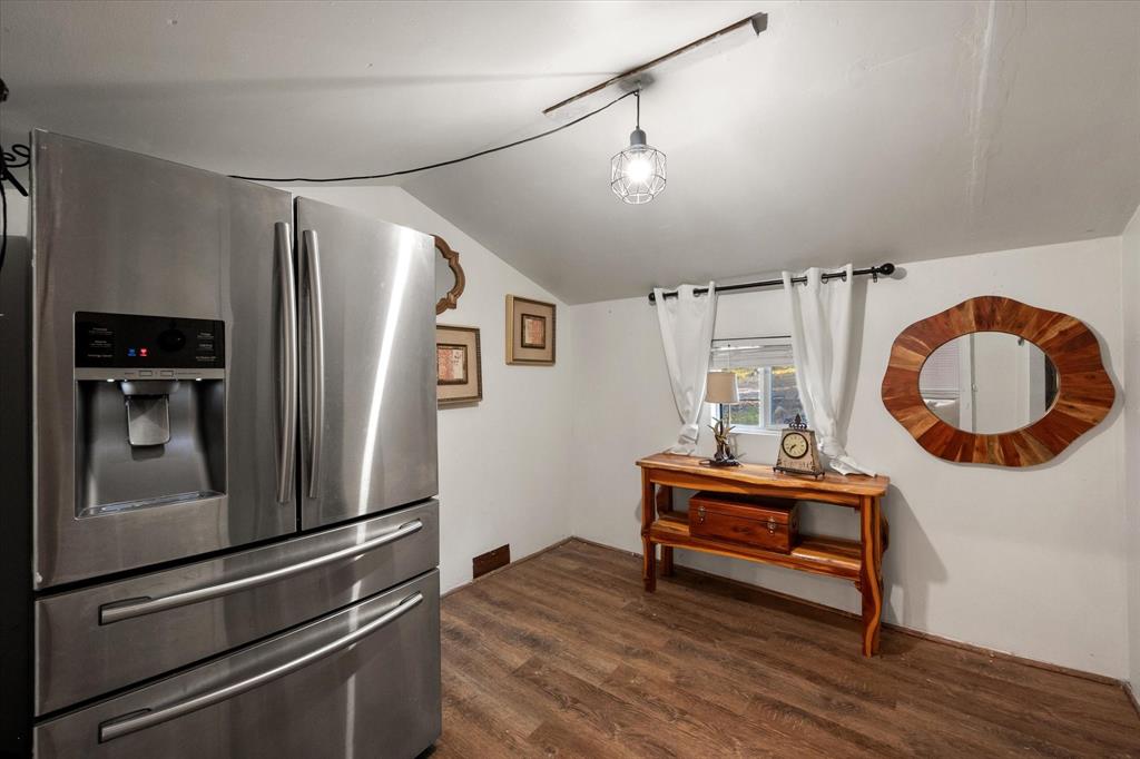 734 Interstate 45 Teague, TX 75860 - Photo 6 of 19 a kitchen with granite countertop a refrigerator and a wooden floor
