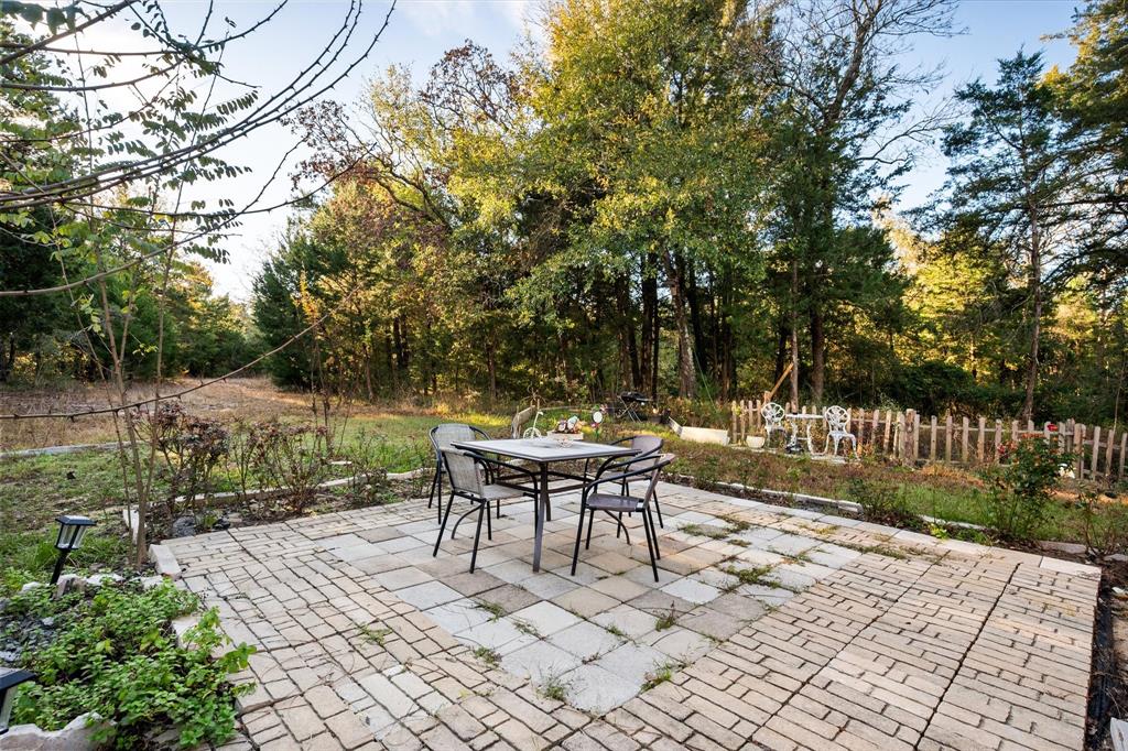 734 Interstate 45 Teague, TX 75860 - Photo 10 of 19 a backyard of a house with table and chairs