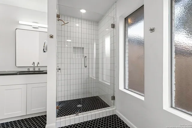 a bathroom with a shower and a sink