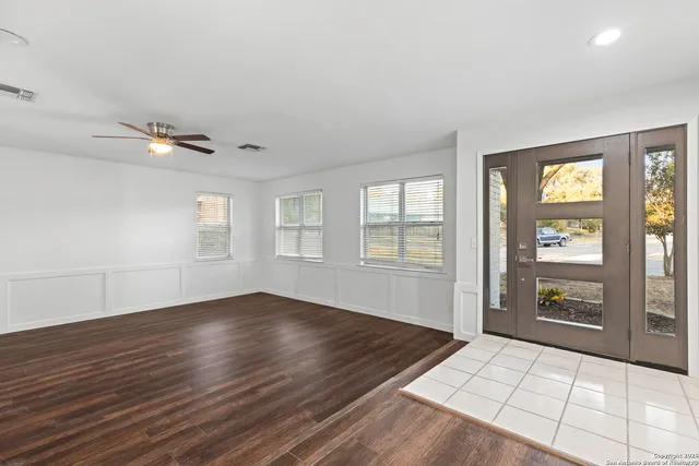 an empty room with windows and closet