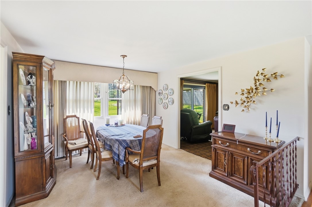 6225 Possum Run Road Bellbrook, OH 45305 - Photo 6 of 33 This formal dining space features carpet flooring and an elegant chandelier.