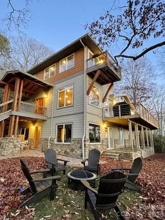 a front view of a house with lots of trees