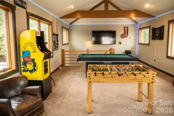 a living room with furniture and a floor to ceiling window