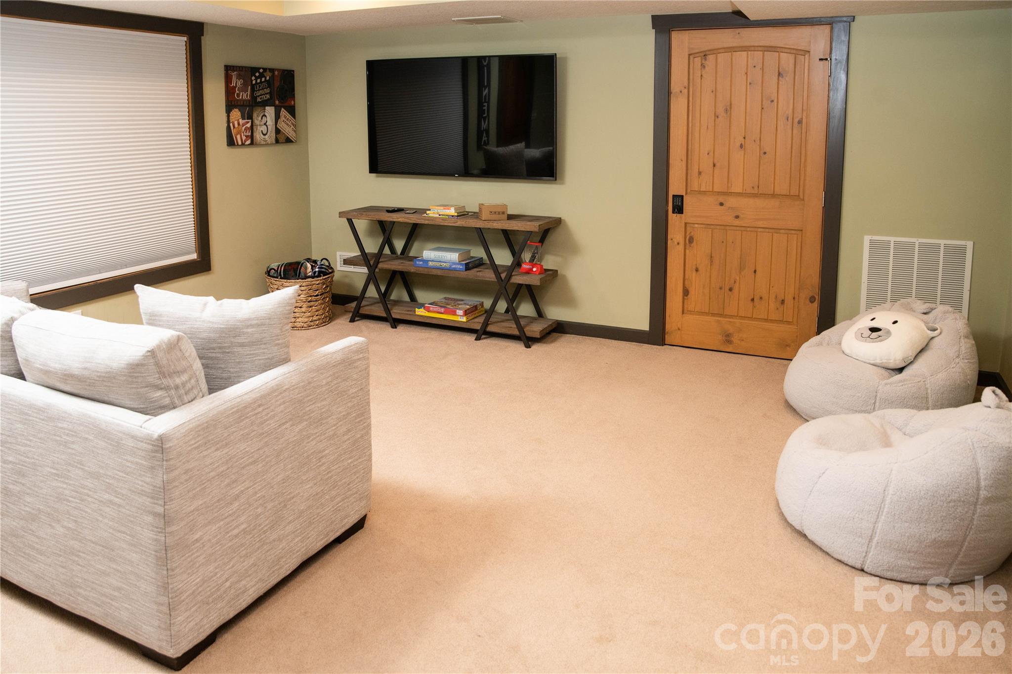425 Flat Top Mountain Road Fairview, NC 28730 - Photo 18 of 48 a living room with furniture and a flat screen tv