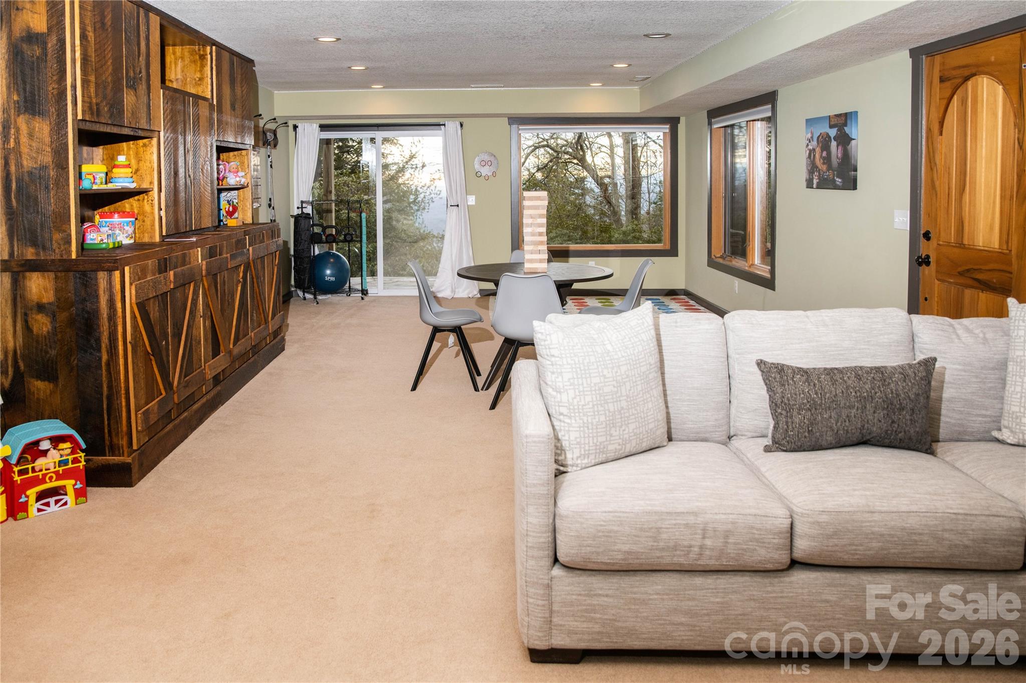 425 Flat Top Mountain Road Fairview, NC 28730 - Photo 19 of 48 a living room with furniture and large windows