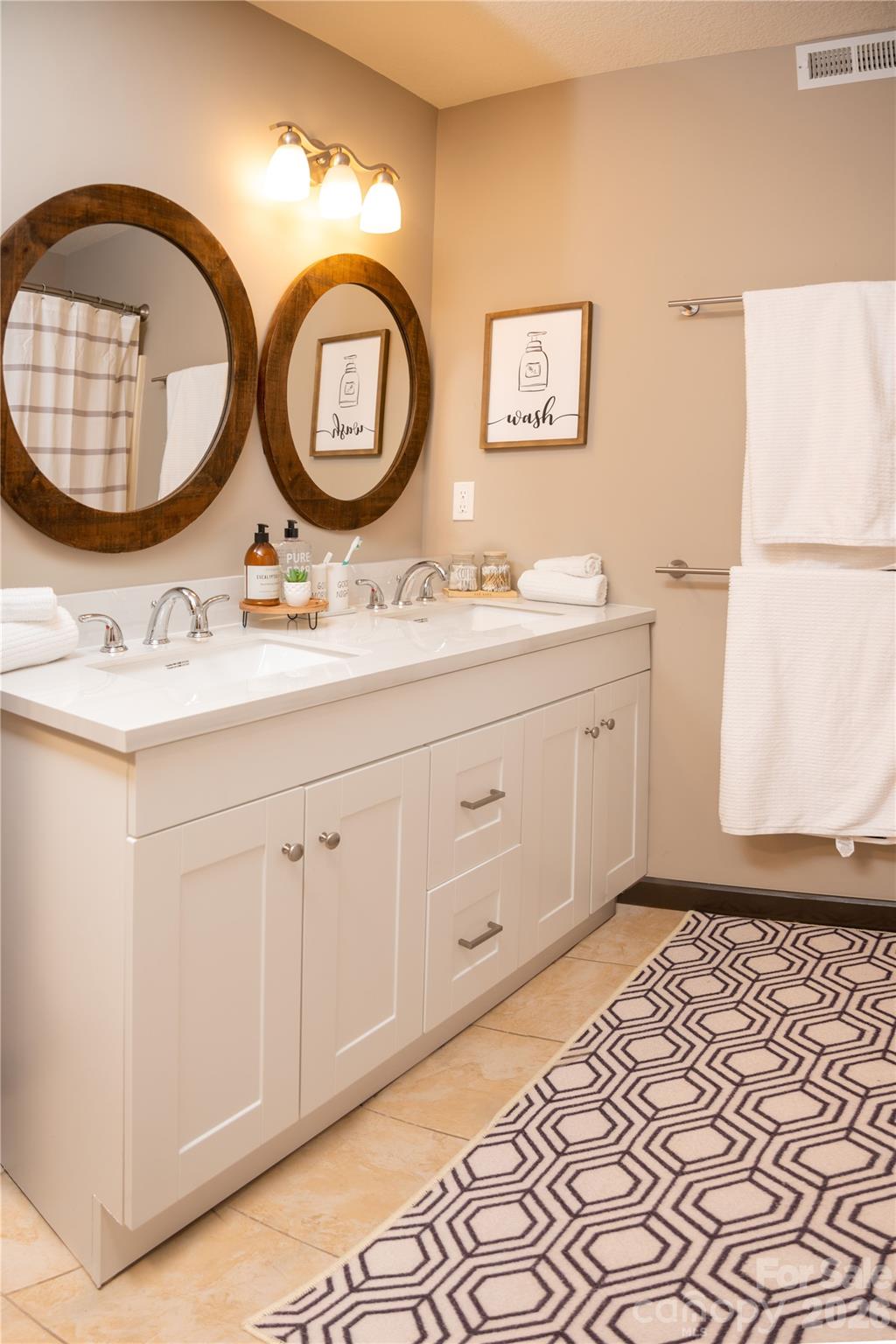 425 Flat Top Mountain Road Fairview, NC 28730 - Photo 22 of 48 a bathroom with a sink and a mirror
