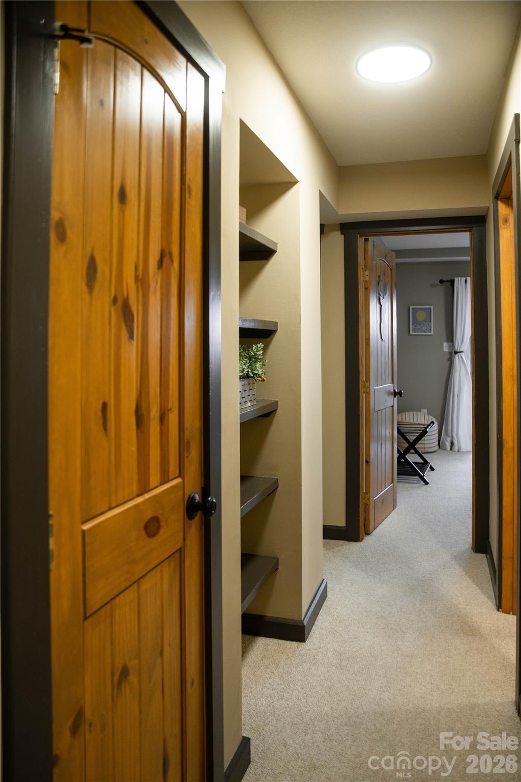 425 Flat Top Mountain Road Fairview, NC 28730 - Photo 23 of 48 a view of a hallway with wooden shelves