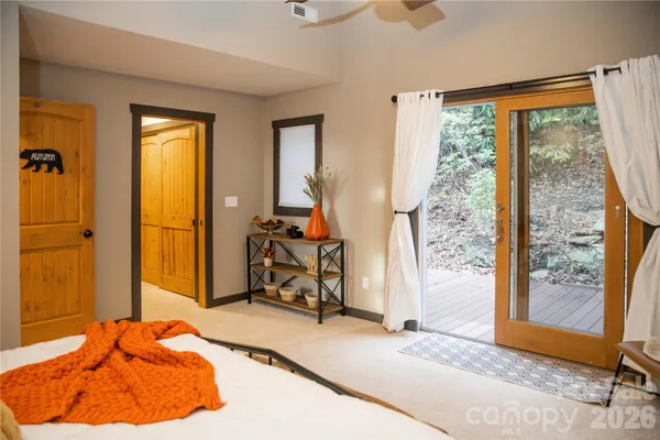 a spacious bedroom with a bed and a chandelier