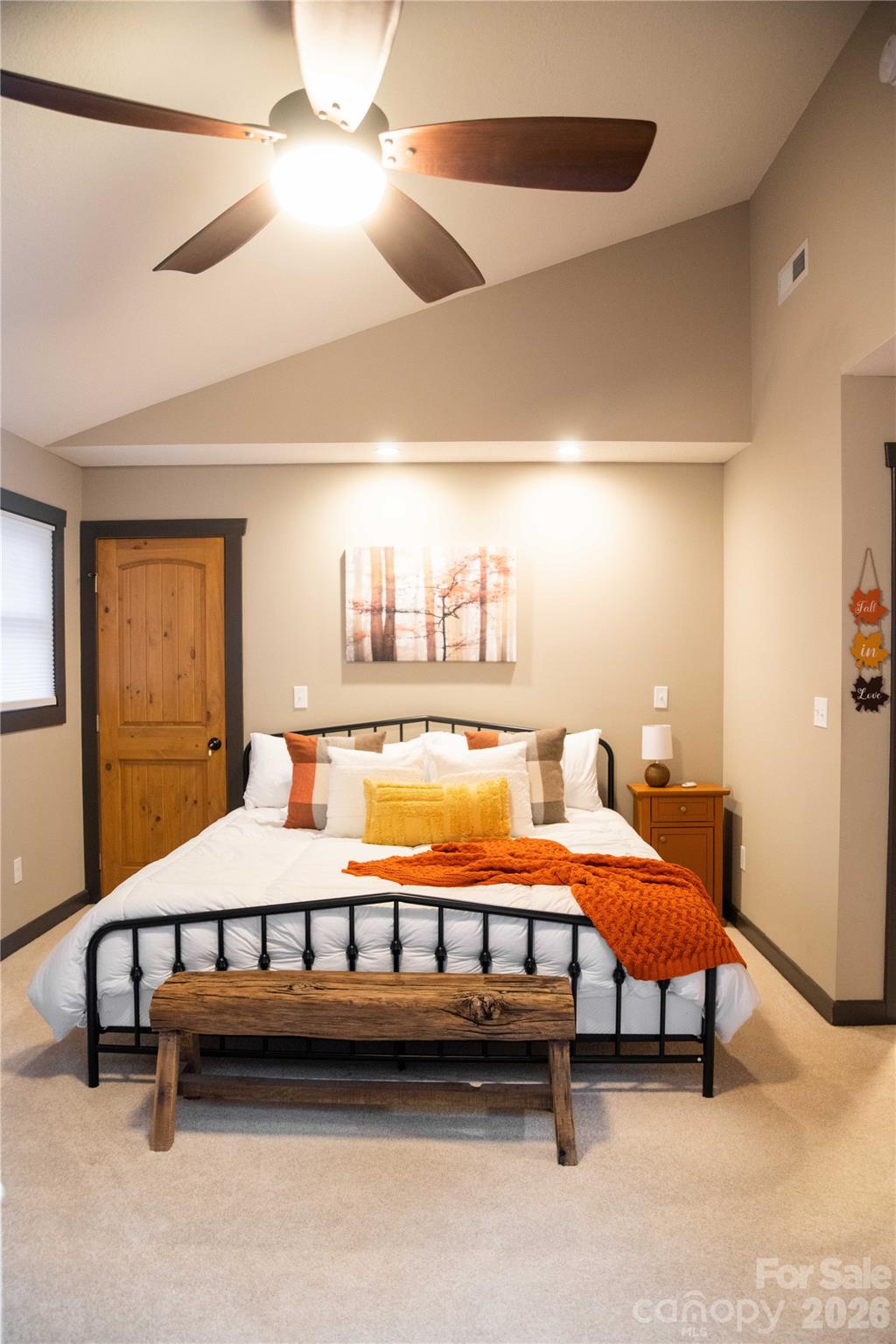 425 Flat Top Mountain Road Fairview, NC 28730 - Photo 26 of 48 a spacious bedroom with a bed and a chandelier