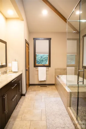 a bathroom with a glass shower door