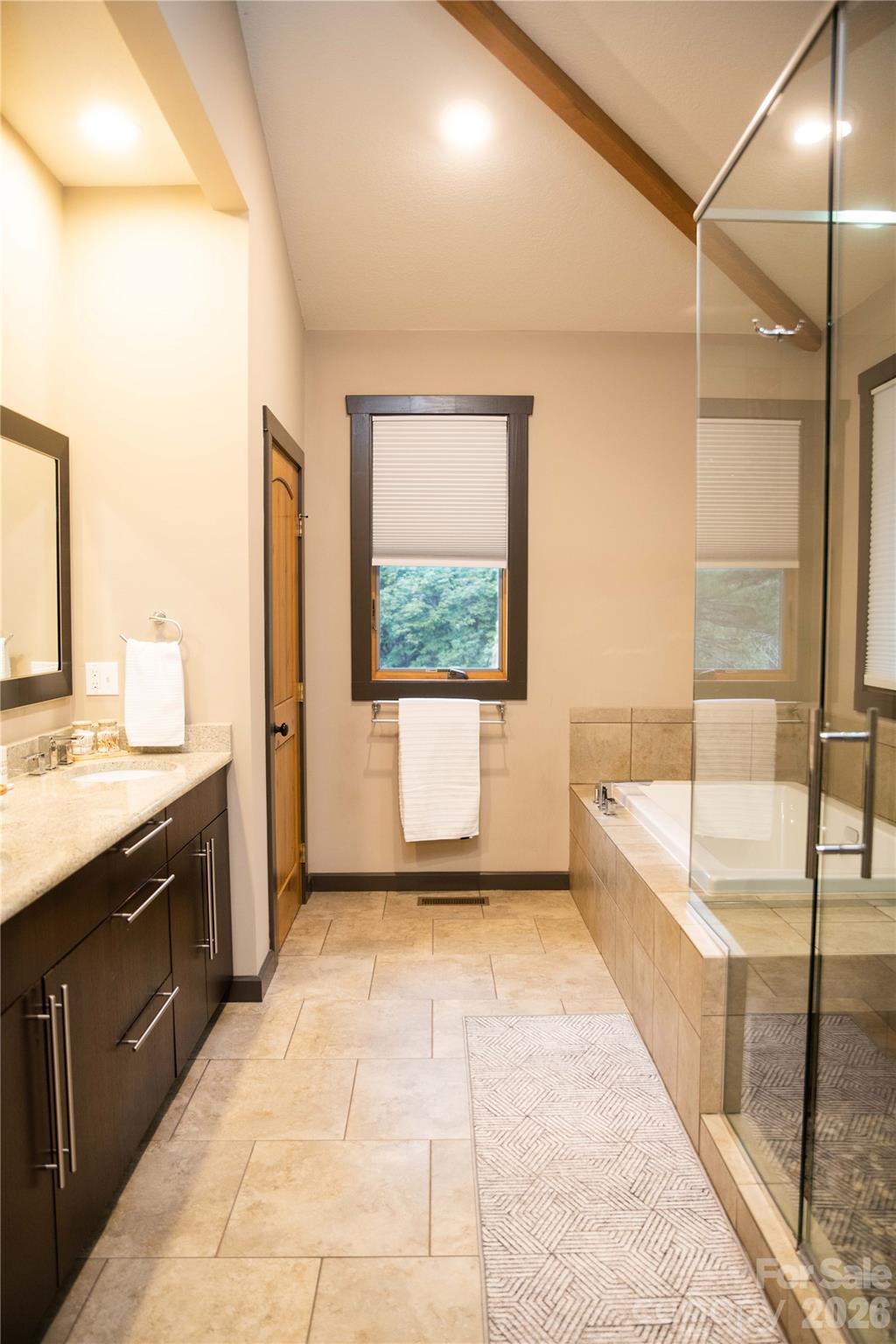 425 Flat Top Mountain Road Fairview, NC 28730 - Photo 29 of 48 a spacious bathroom with a tub sink and mirror