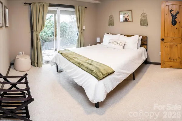 a bedroom with a bed and painting on the wall