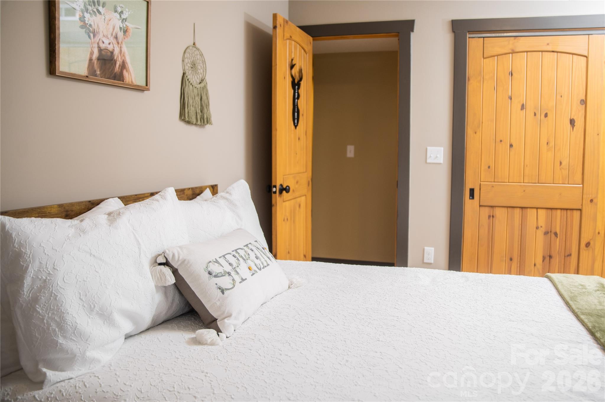 425 Flat Top Mountain Road Fairview, NC 28730 - Photo 36 of 48 a bedroom with a bed and a painting on the wall