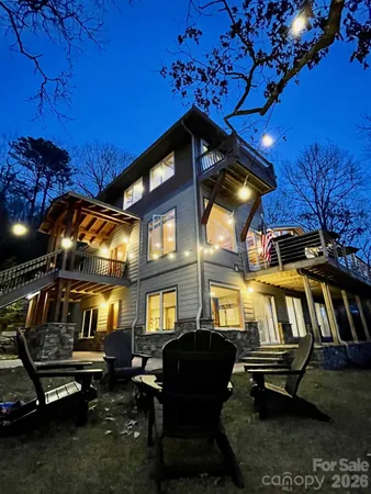 a backyard of a house with fire pit and outdoor seating