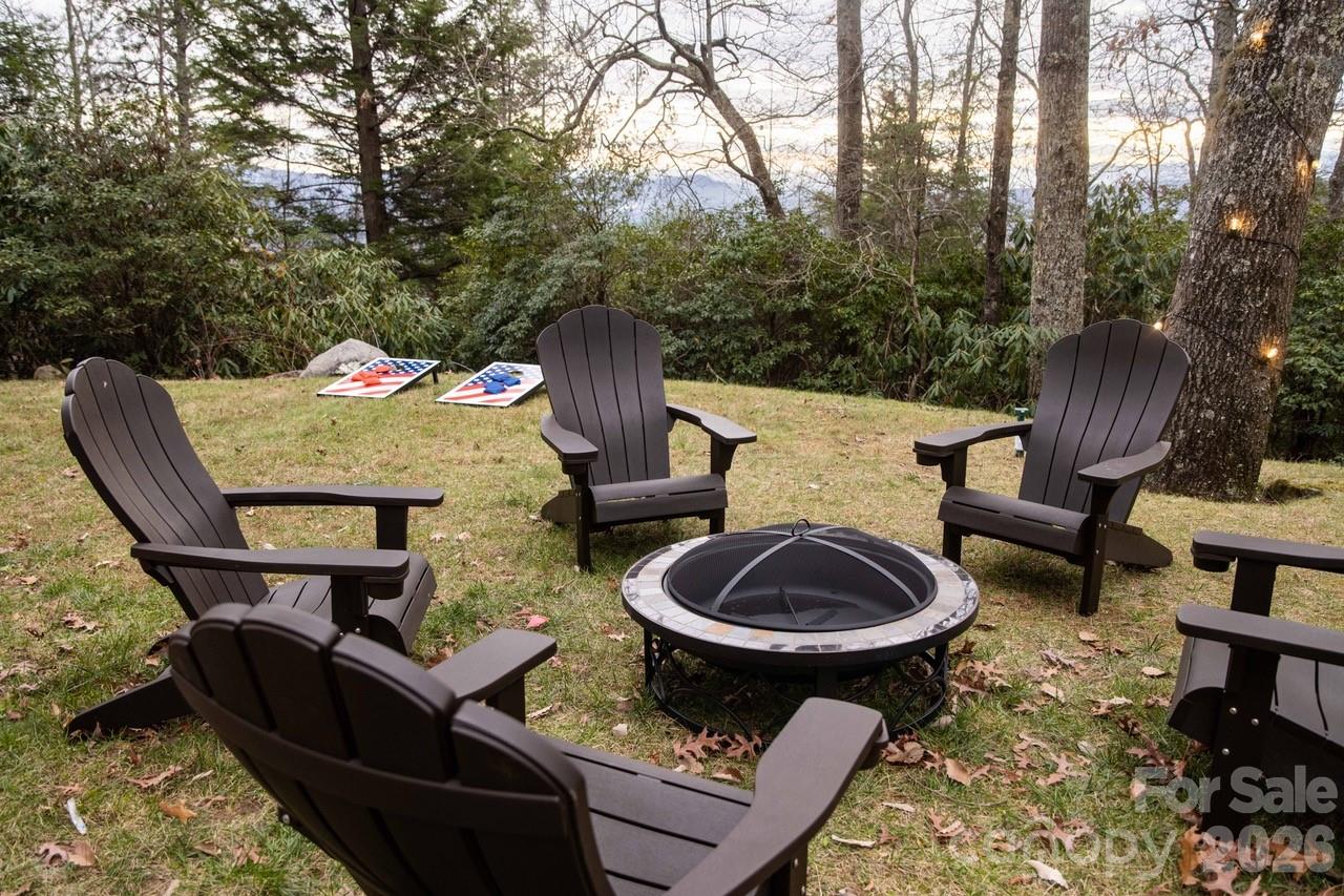 425 Flat Top Mountain Road Fairview, NC 28730 - Photo 42 of 48 a backyard of a house with fire pit and outdoor seating