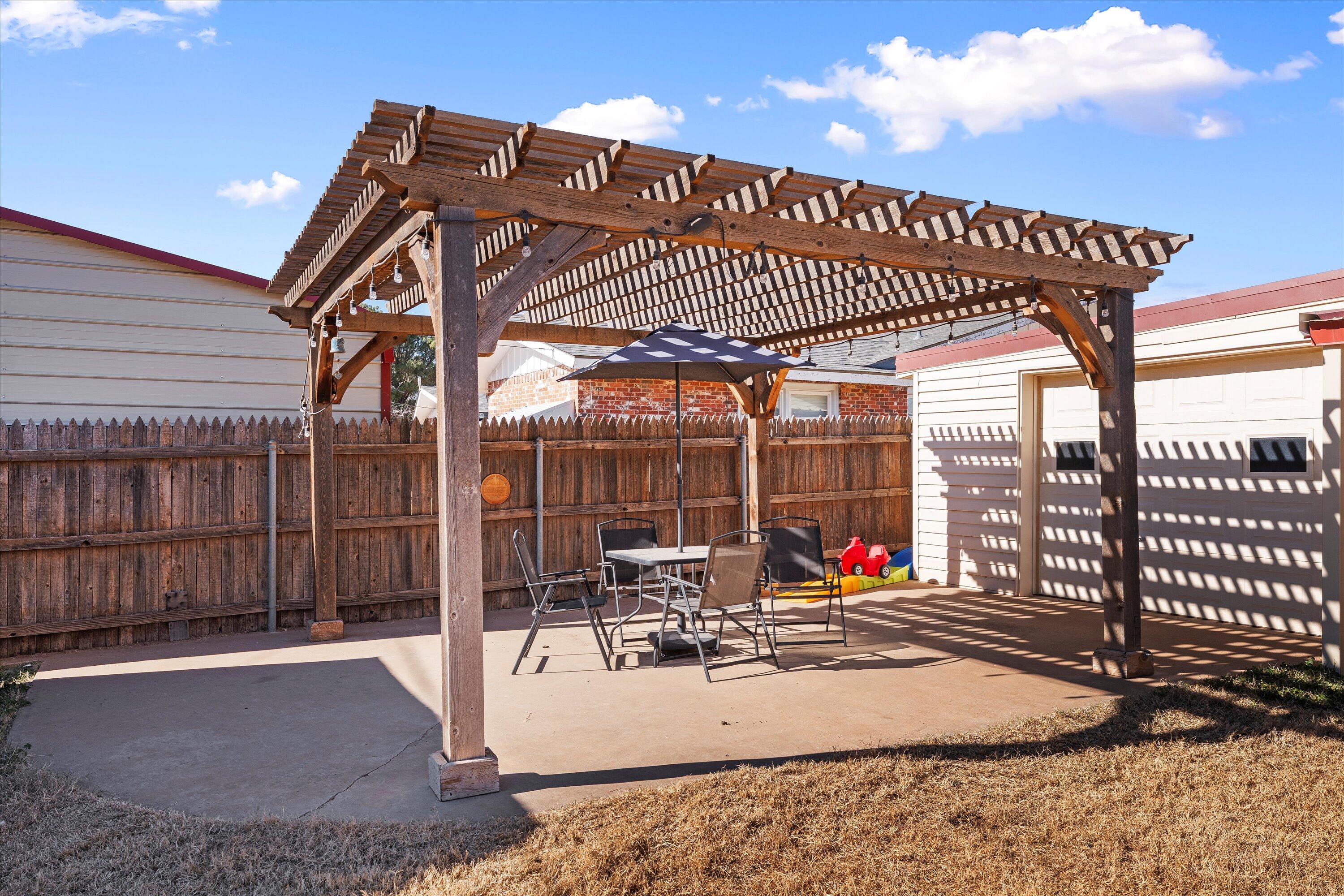 804 2nd Street Plains, TX 79355 - Photo 15 of 18 a patio with table and chairs