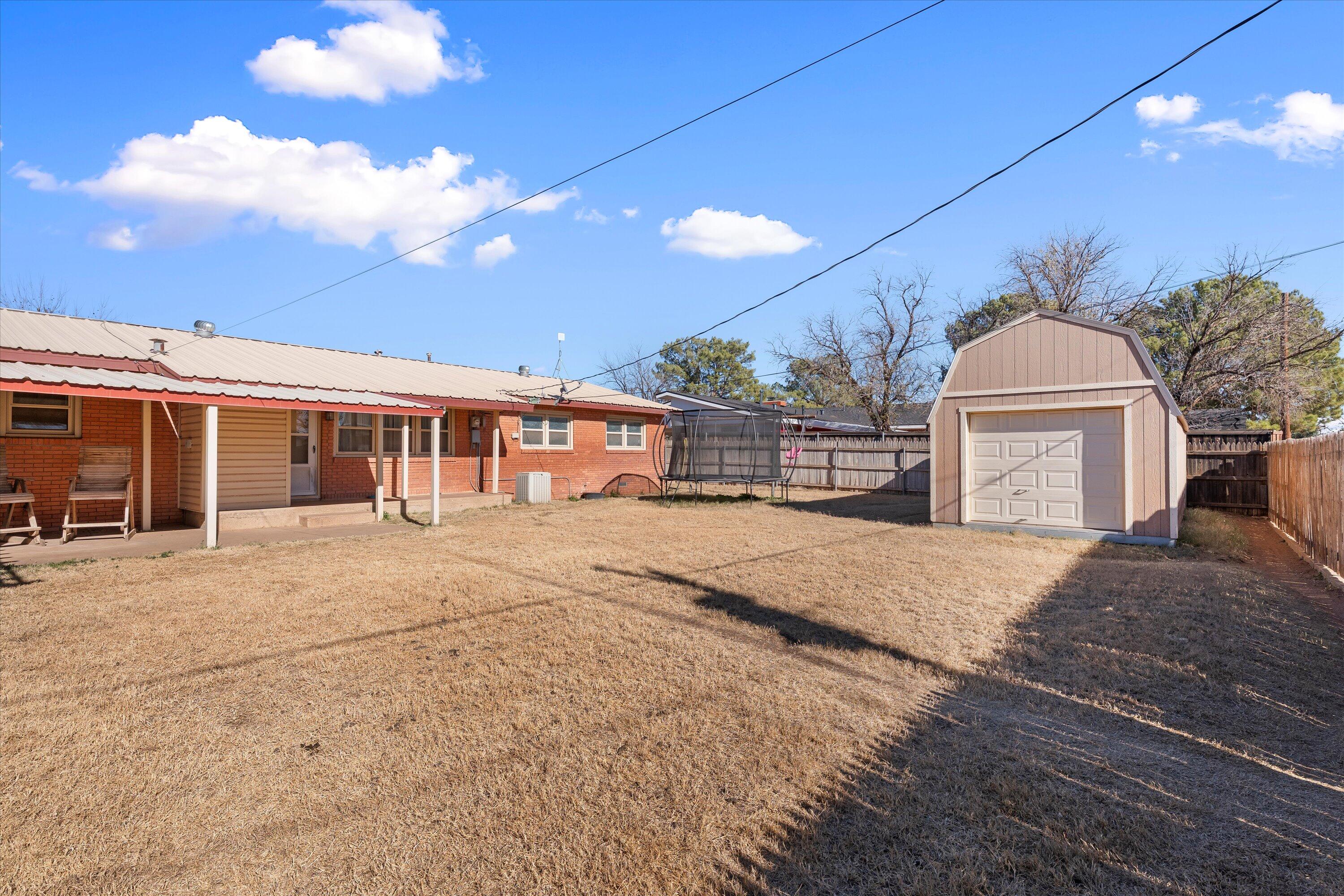804 2nd Street Plains, TX 79355 - Photo 16 of 18 a front view of a house with a yard