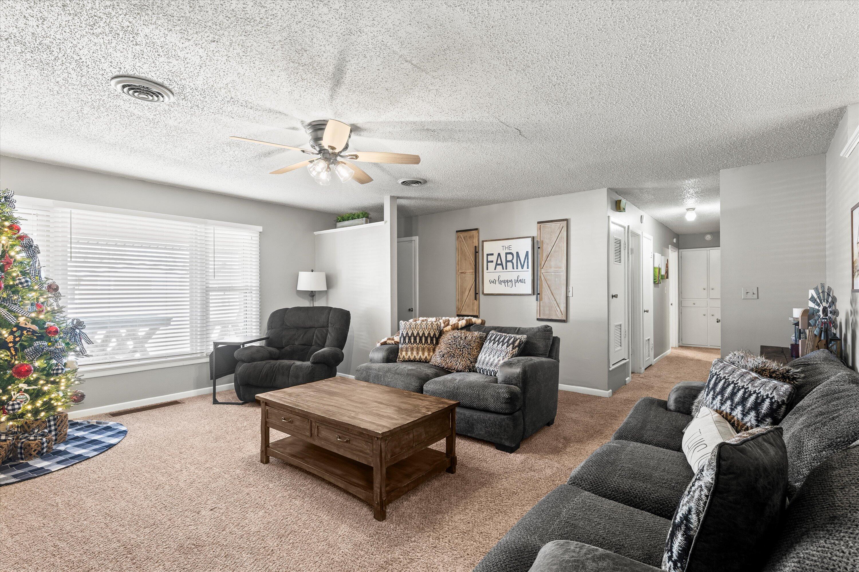 804 2nd Street Plains, TX 79355 - Photo 3 of 18 a living room with furniture and a large window