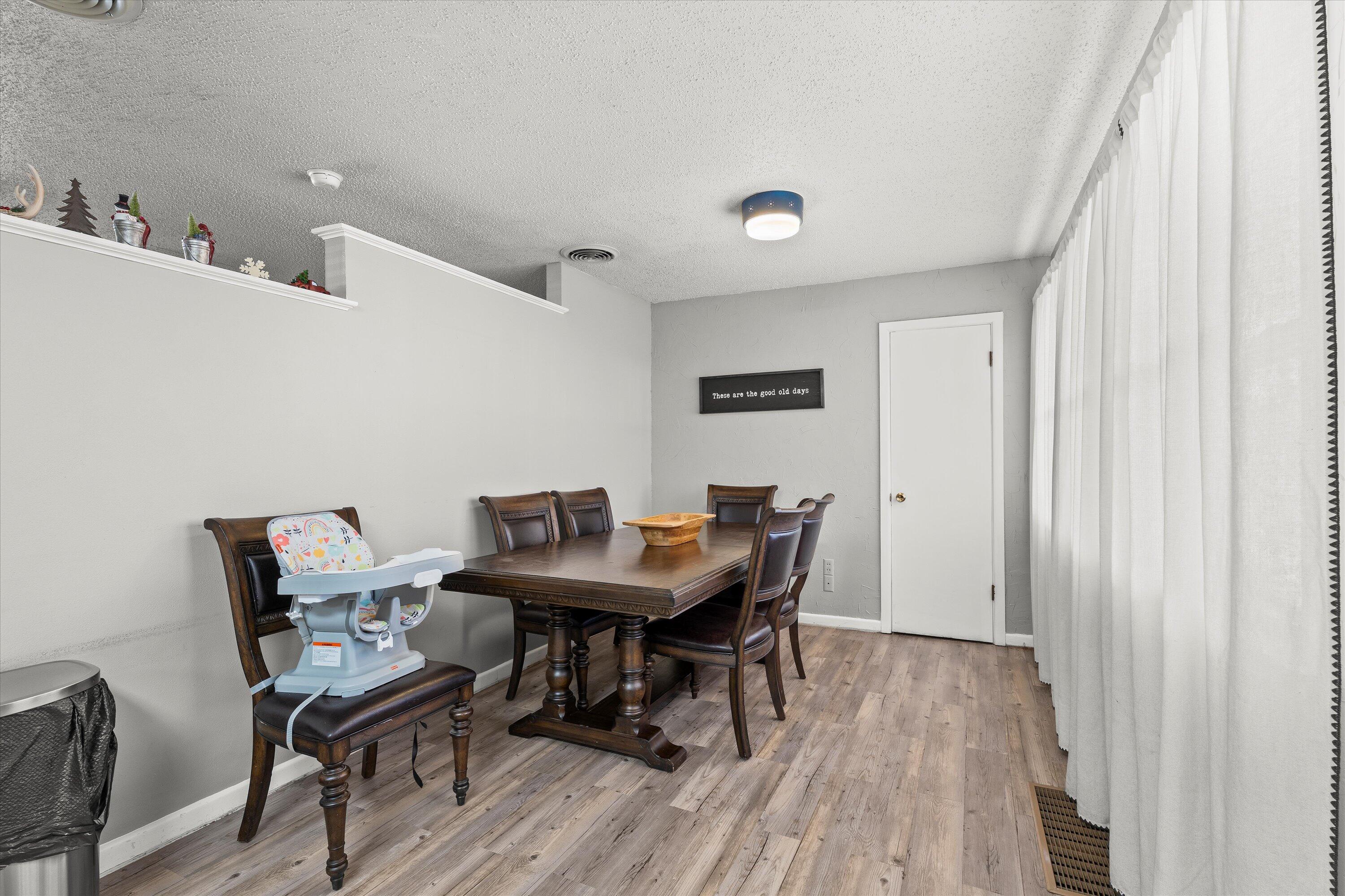 804 2nd Street Plains, TX 79355 - Photo 5 of 18 a view of a dining room with furniture and wooden floor