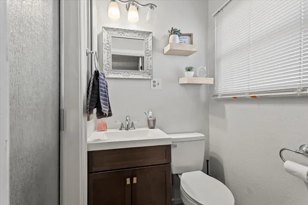 a bathroom with a sink toilet and mirror