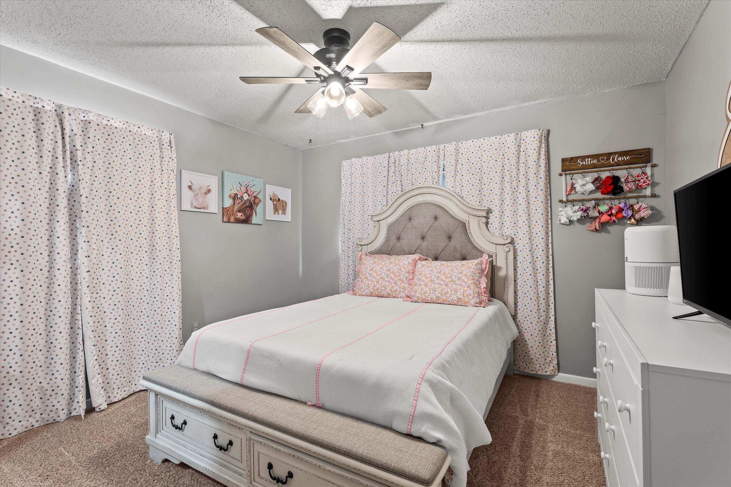 804 2nd Street Plains, TX 79355 - Photo 8 of 18 a bedroom with a bed and a flat screen tv