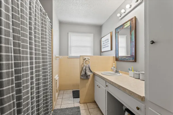 a bathroom with a sink a vanity and a mirror