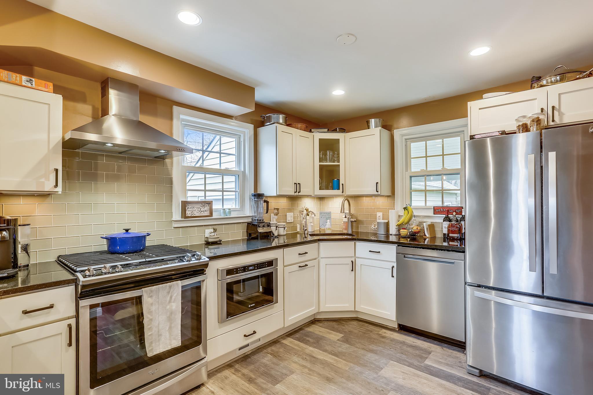 616 Olney Sandy Spring Road Sandy Spring, MD 20860 - Photo 6 of 31 a kitchen with stainless steel appliances a sink dishwasher a refrigerator and a stove with wooden floor