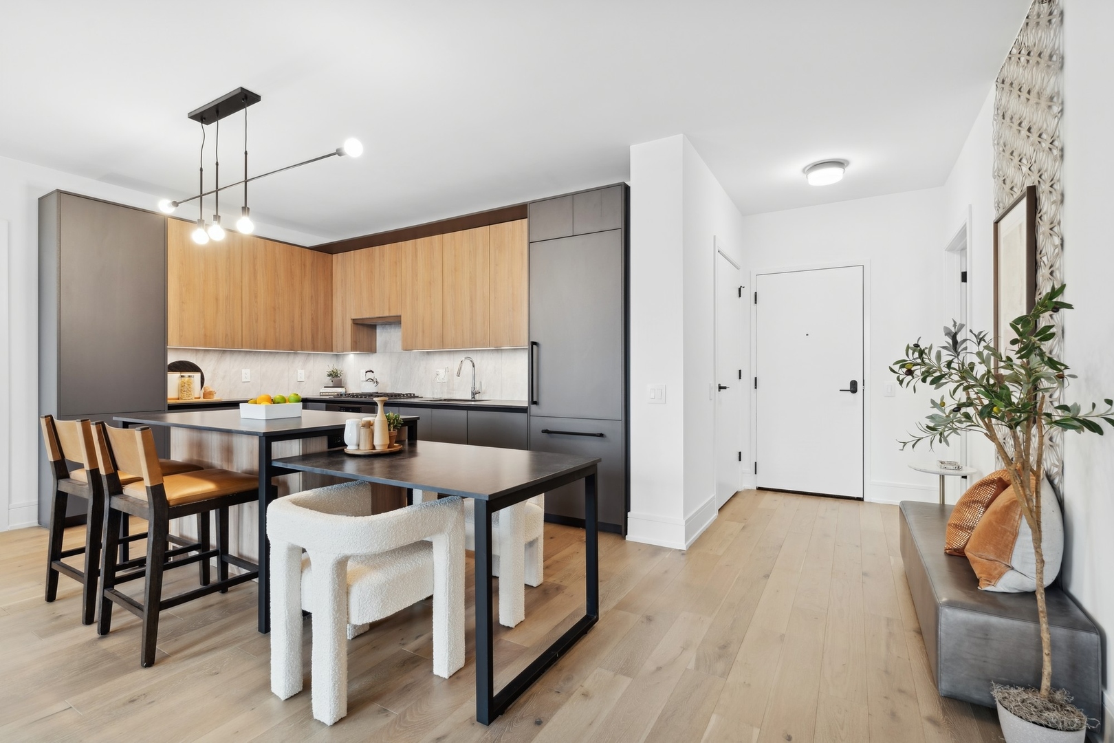 234 West Polk Street, Unit 3204 Chicago, IL 60607 - Photo 12 of 39 a kitchen with stainless steel appliances kitchen island granite countertop a table chairs refrigerator and sink