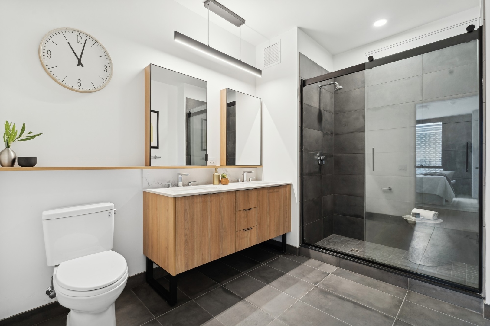 234 West Polk Street, Unit 3204 Chicago, IL 60607 - Photo 17 of 39 a bathroom with a double vanity sink mirror and toilet