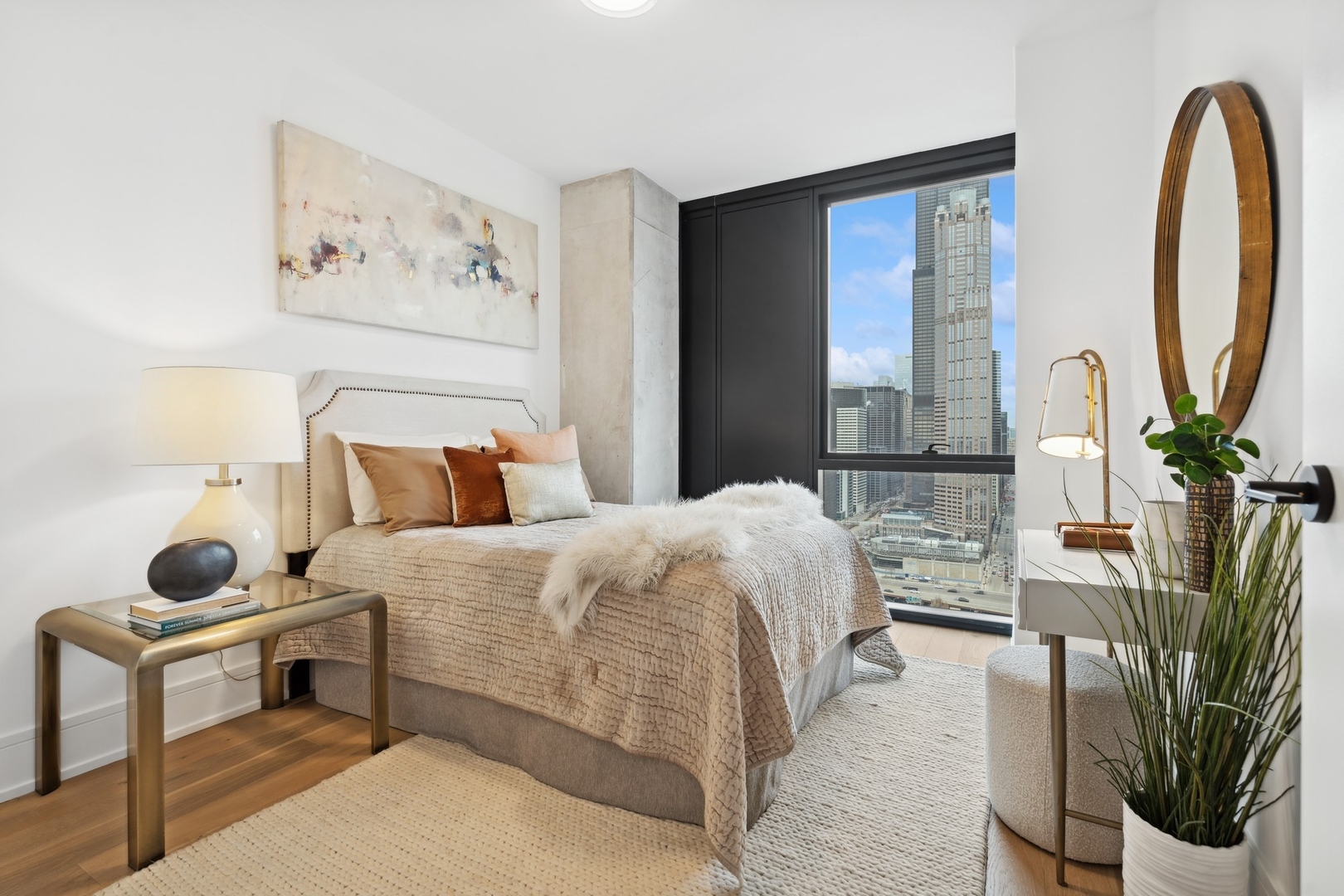 234 West Polk Street, Unit 3204 Chicago, IL 60607 - Photo 18 of 39 a bedroom with a bed a mirror and a potted plant