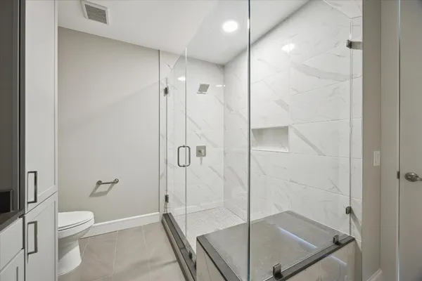 a bathroom with a shower and a toilet