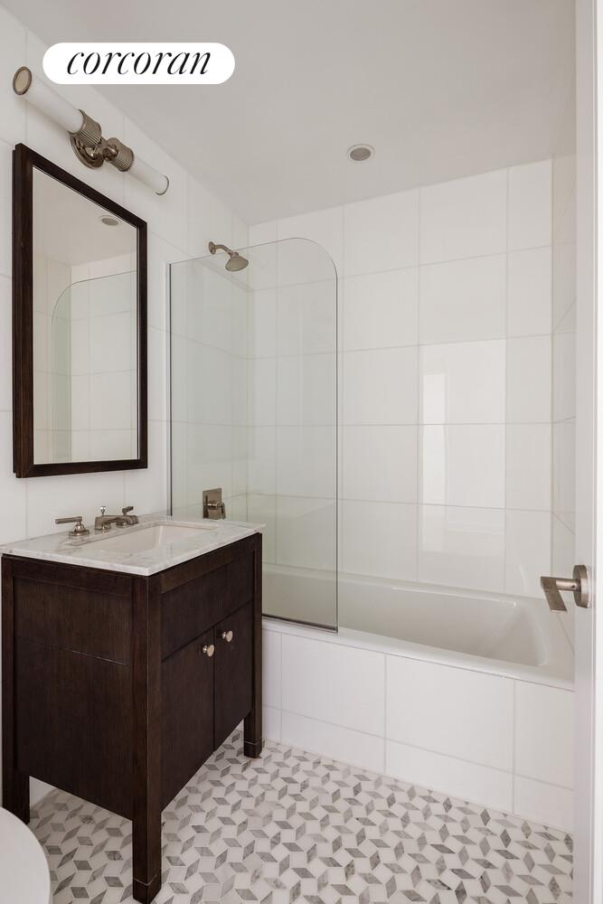80 Riverside Boulevard, Unit 36B Manhattan, NY 10069 - Photo 15 of 25 a bathroom with a sink a toilet and mirror