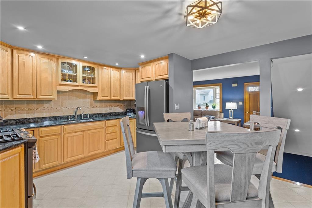 90 Davis Road Coraopolis, PA 15108 - Photo 11 of 29 a dining room with granite countertop a table chairs and granite counter tops
