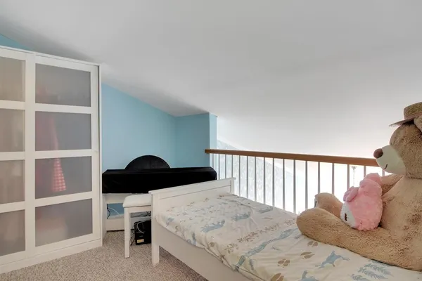 a bedroom with a bed and window