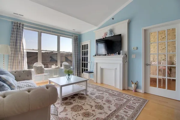 a living room with furniture a flat screen tv and a fireplace