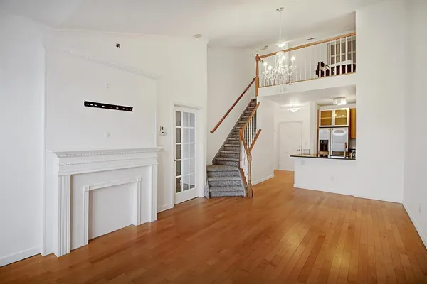 a view of a livingroom with wooden floor and a ceiling fan