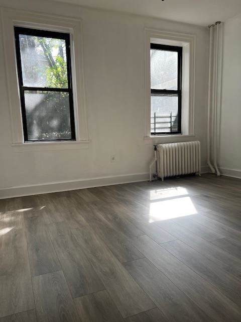 331 79th Street, Unit 15 North Bergen, NJ 07047 - Photo 12 of 13 an empty room with wooden floor and windows
