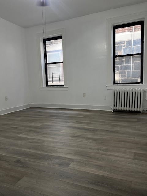 331 79th Street, Unit 15 North Bergen, NJ 07047 - Photo 6 of 13 an empty room with wooden floor and windows