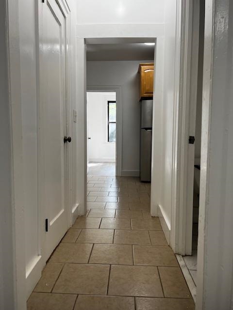331 79th Street, Unit 15 North Bergen, NJ 07047 - Photo 7 of 13 a view of a hallway with a glass door and a bathroom in it