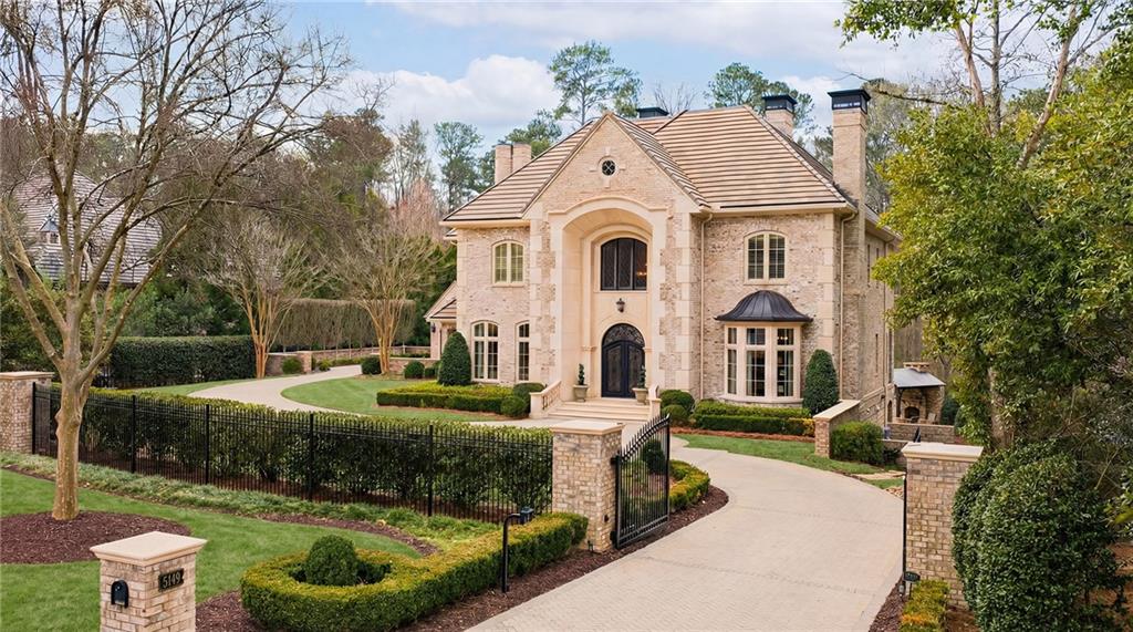 5148 Powers Ferry Road Northwest Sandy Springs, GA 30327 - Photo 1 of 63 a large white building with a white roof and yard